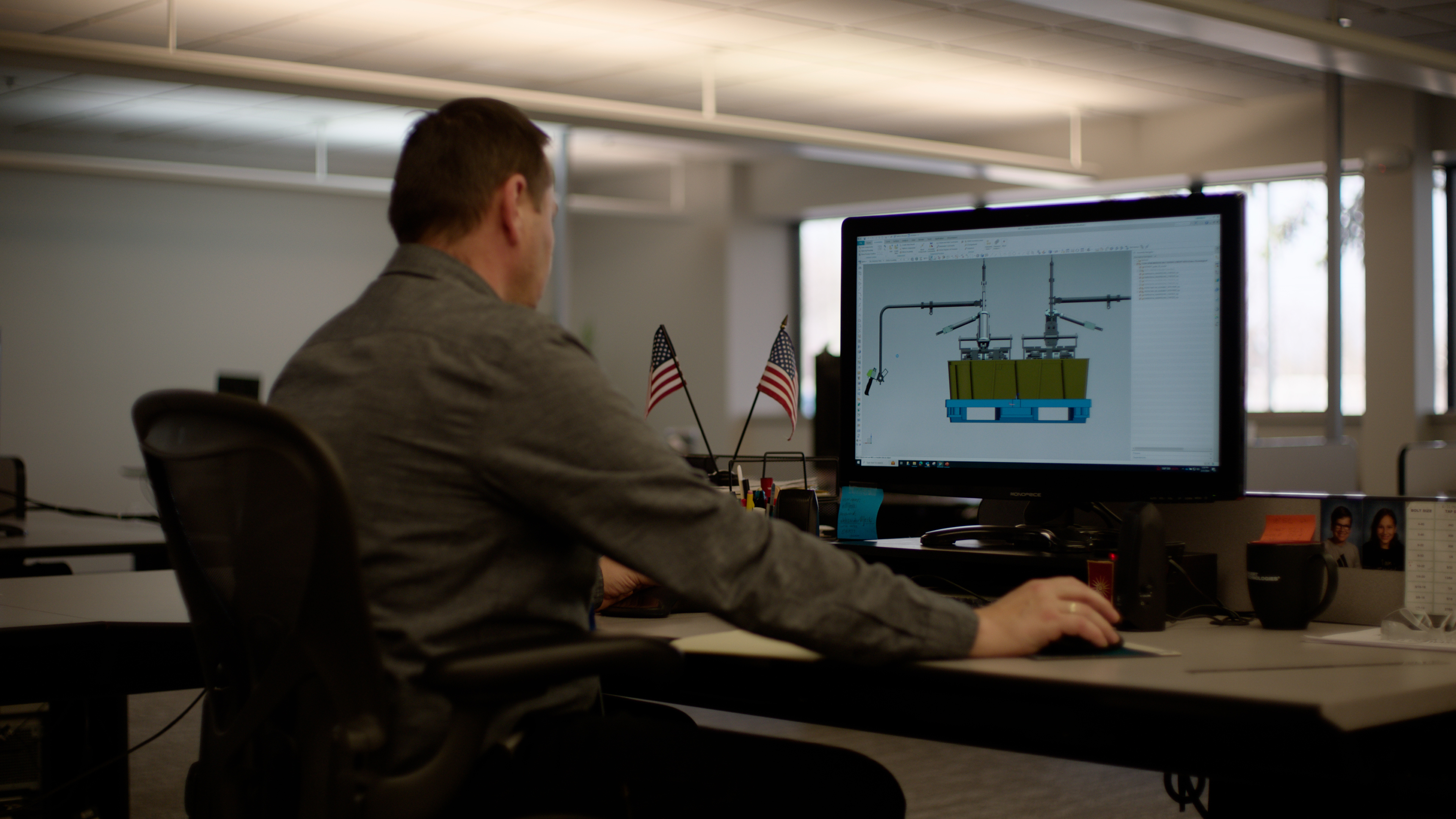 Shuert engineer reviewing technical designs at a workstation